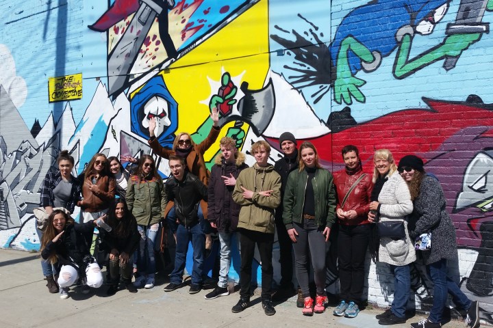 group standing in front of graffiti