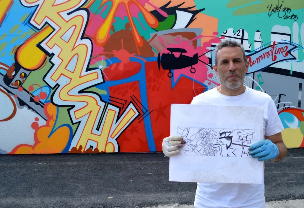 John “Crash” Matos with his sketch in front of his new Wall