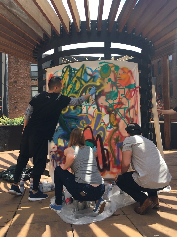 group painting graffiti outside