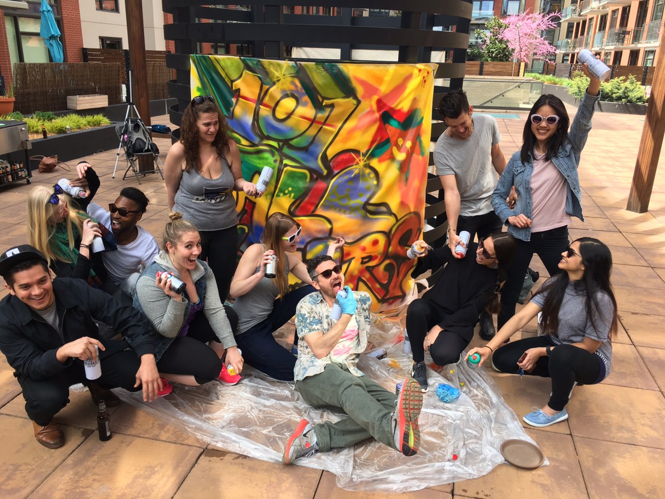 group posing in front of graffiti