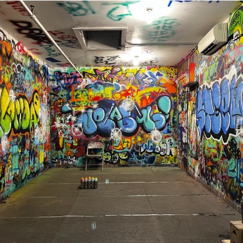 graffiti on a wall above a store