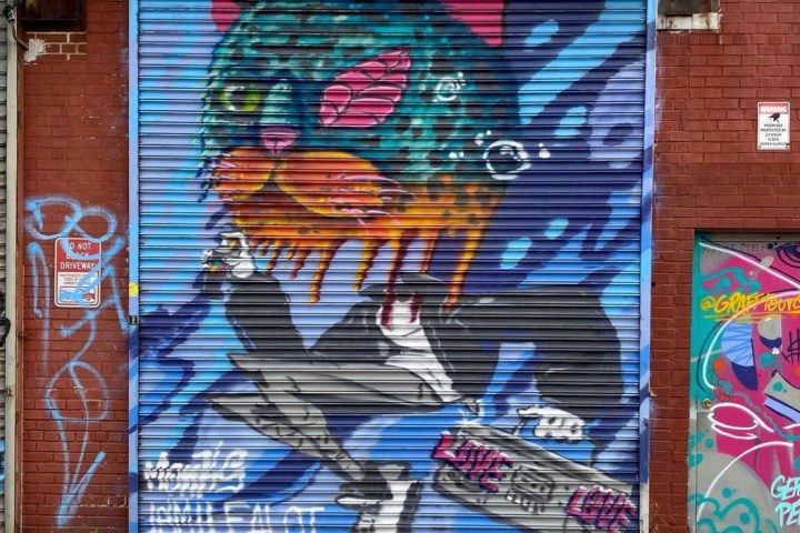 a building with graffiti on the side of a brick wall